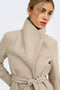 Front image of a model wearing the Trish wrap coat in light brown, by brand Only