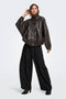 Front image of a model wearing the Yasmine mw pleat barrel pant in black, by brand Only