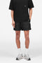 Front image of a model wearing Micro owners club swimshorts in black, by brand Represent