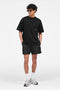 Front image of a model wearing the Micro owners club swimshorts in black, by brand Represent