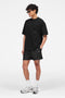 Front image of a model wearing the Micro owners club swimshorts in black, by brand Represent