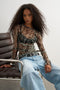 Front image of a model wearing the Beate ls crewneck mesh top in black, by brand Top shop