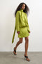 Front image of a model wearing Ceren satin scarf tie mini dress in green, by brand Top shop
