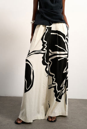 Front image of a model wearing Fiona wide leg trousers in off white, by brand Top shop