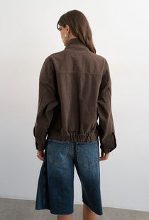 Back image of a model wearing the Freya denim jacket in brown, by brand Top shop