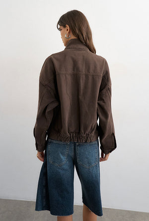 Back image of a model wearing the Freya denim jacket in brown, by brand Top shop