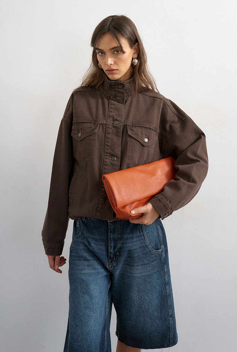 Front image of a model wearing Freya denim jacket in brown, by brand Top shop
