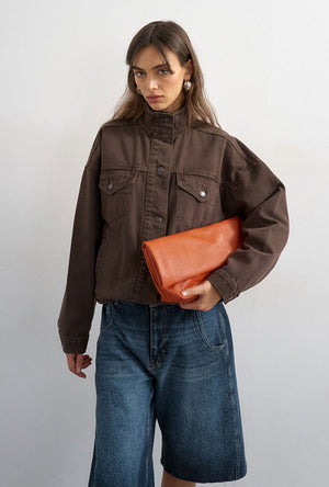 Front image of a model wearing the Freya denim jacket in brown, by brand Top shop