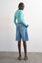 Back image of a model wearing the Joa denim barrel jort in denim, by brand Top shop