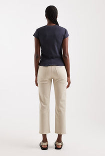 Back image of a model wearing the Orson mid rise jeans in beige, by brand Top shop