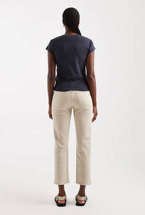 Back image of a model wearing the Orson mid rise jeans in beige, by brand Top shop