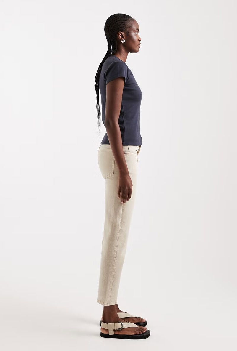 Front image of a model wearing Orson mid rise jeans in beige, by brand Top shop
