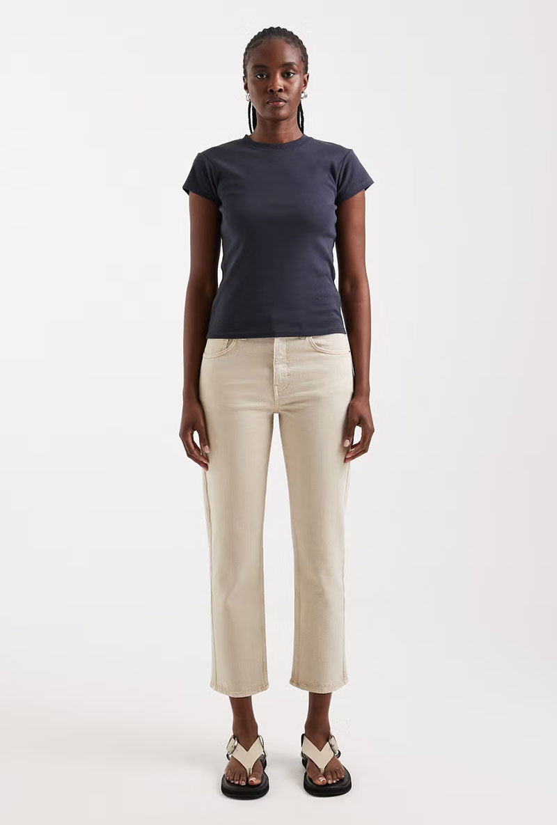 Front image of a model wearing Orson mid rise jeans in beige, by brand Top shop