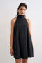 Front image of a model wearing Sara sl trapeze mini dress in black, by brand Top shop