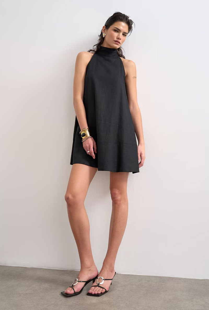 Front image of a model wearing Sara sl trapeze mini dress in black, by brand Top shop