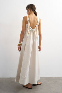 Back image of a model wearing the Selena open back maxi dress in beige, by brand Top shop