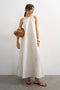 Front image of a model wearing Selena open back maxi dress in beige, by brand Top shop
