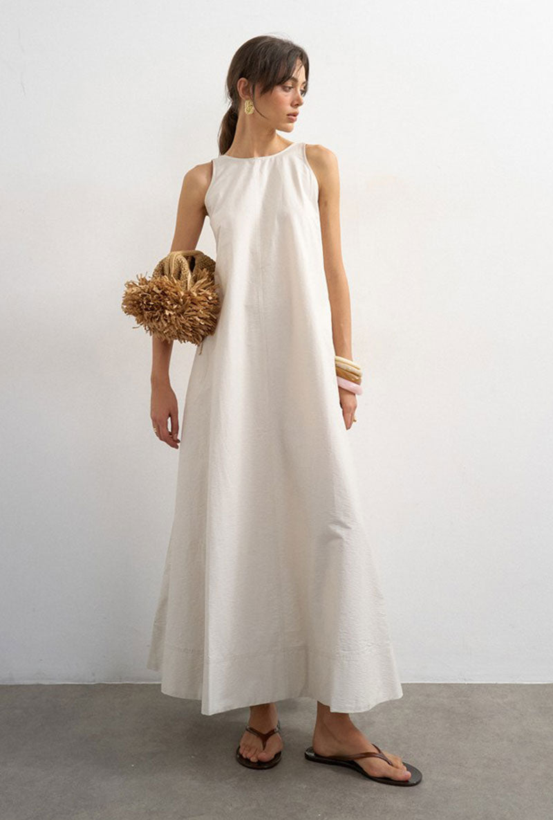 Front image of a model wearing Selena open back maxi dress in beige, by brand Top shop