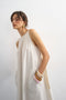 Front image of a model wearing the Selena open back maxi dress in beige, by brand Top shop