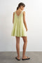 Back image of a model wearing the Sophie deep v mini dress in lime, by brand Top shop