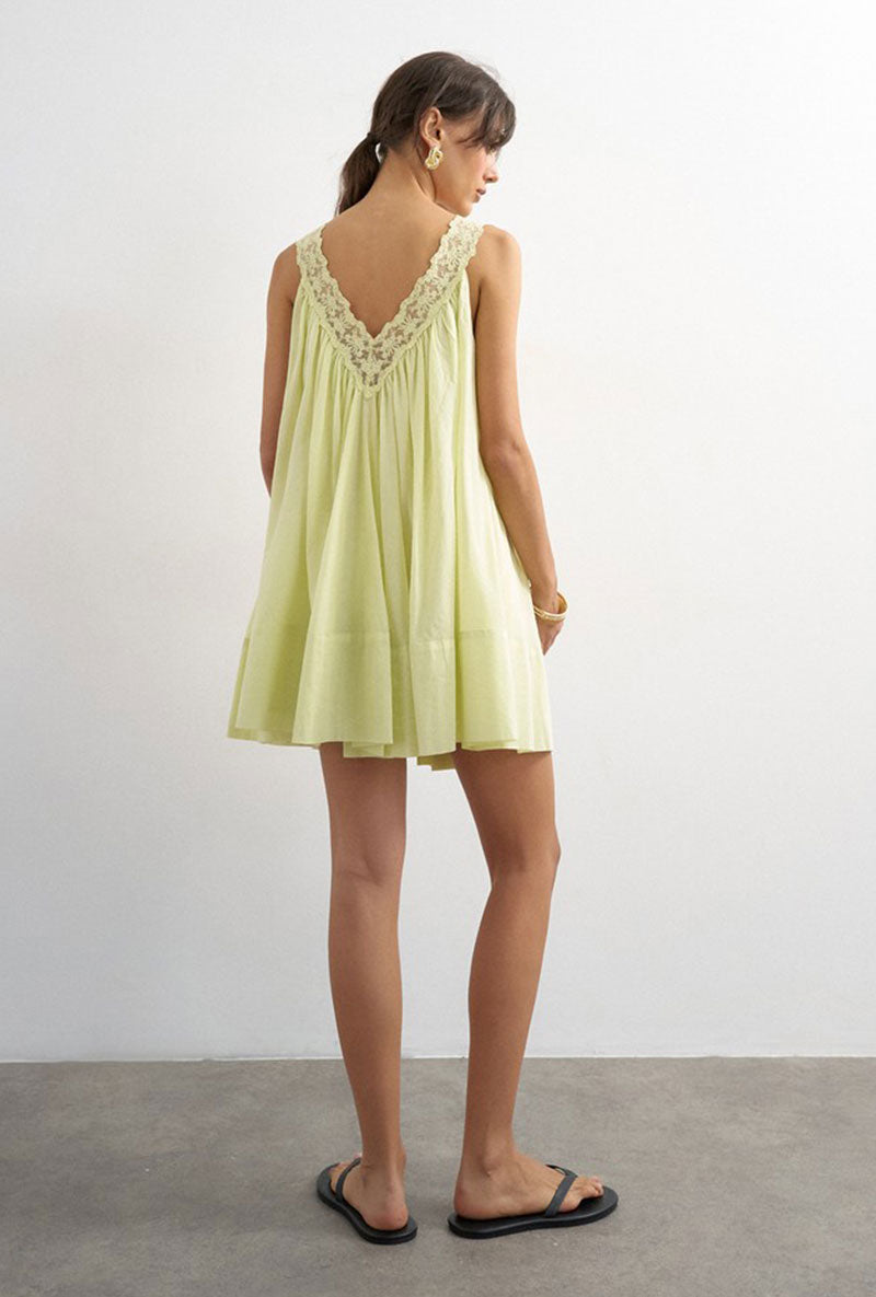 Back image of a model wearing Sophie deep v mini dress in lime, by brand Top shop