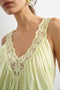 Front image of a model wearing the Sophie deep v mini dress in lime, by brand Top shop