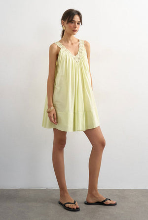 Front image of a model wearing the Sophie deep v mini dress in lime, by brand Top shop