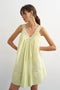 Front image of a model wearing the Sophie deep v mini dress in lime, by brand Top shop