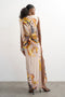 Back image of a model wearing the Vana tie neck maxi dress in beige, by brand Top shop
