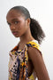 Front image of a model wearing the Vana tie neck maxi dress in beige, by brand Top shop