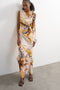 Front image of a model wearing the Vana tie neck maxi dress in beige, by brand Top shop