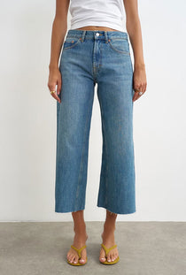 Front image of a model wearing the Vera hr wide cropped jeans in denim, by brand Top shop