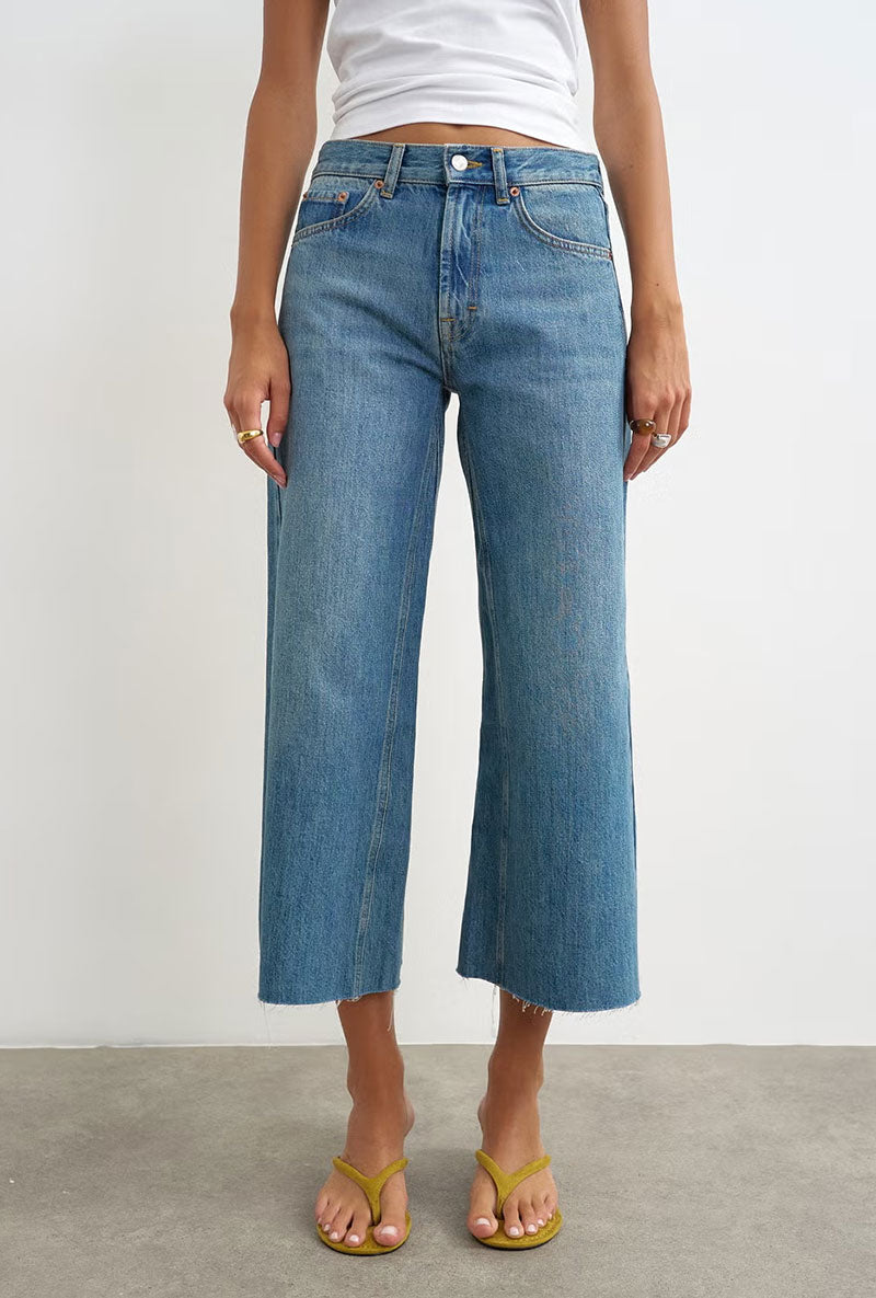 Front image of a model wearing Vera hr wide cropped jeans in denim, by brand Top shop