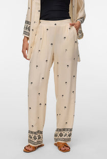 Front image of a model wearing the Kai mw pants in beige, by brand Vero moda