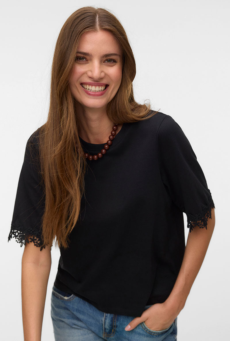Front image of a model wearing Lyla ss oneck top in black, by brand Vero moda