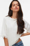 Front image of a model wearing the Lyla ss oneck top in white, by brand Vero moda