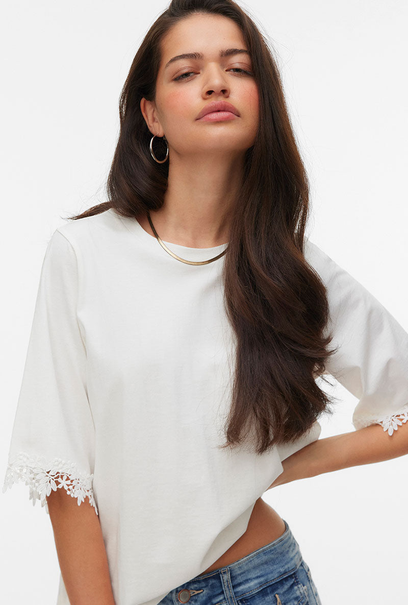 Front image of a model wearing Lyla ss oneck top in white, by brand Vero moda