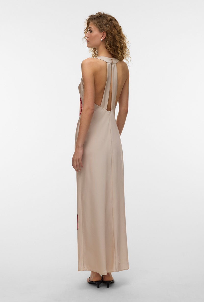 Back image of a model wearing Reba hibisca ankle dress in beige, by brand Vero moda