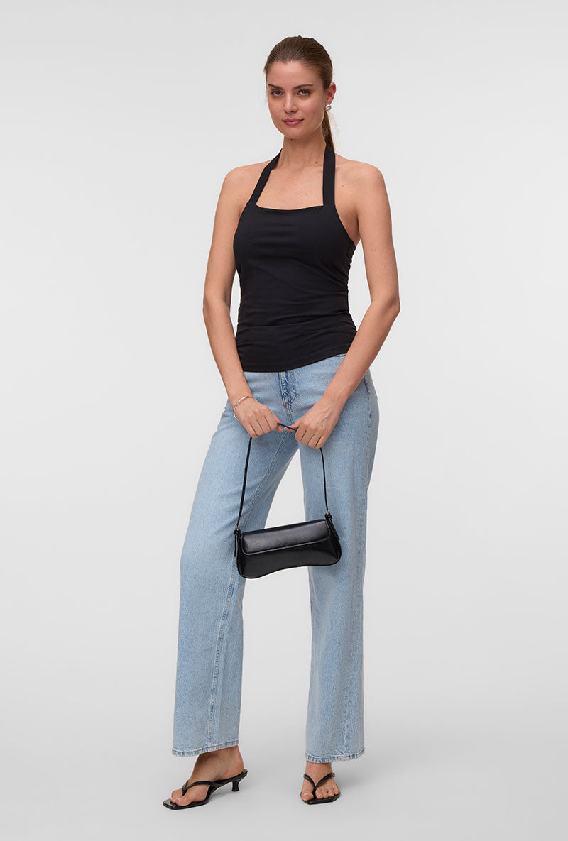 Front image of a model wearing Valerie halterneck top in black, by brand Vero moda
