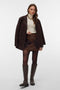 Front image of a model wearing the Darla nw short skirt in brown, by brand Vero moda