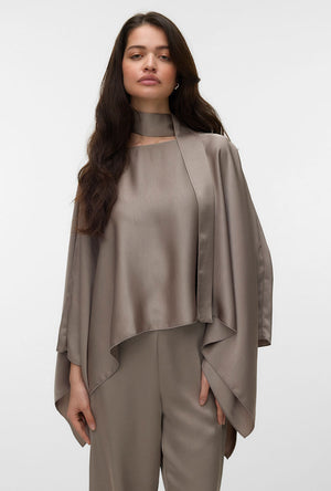 Front image of a model wearing the Miro ls cape scarf top in bronze, by brand Vero moda