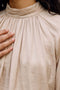 Front image of a model wearing the Sunny ls top in cream, by brand Vero moda