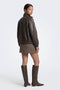 Back image of a model wearing the Violeta hw check slit skirt in brown, by brand Only